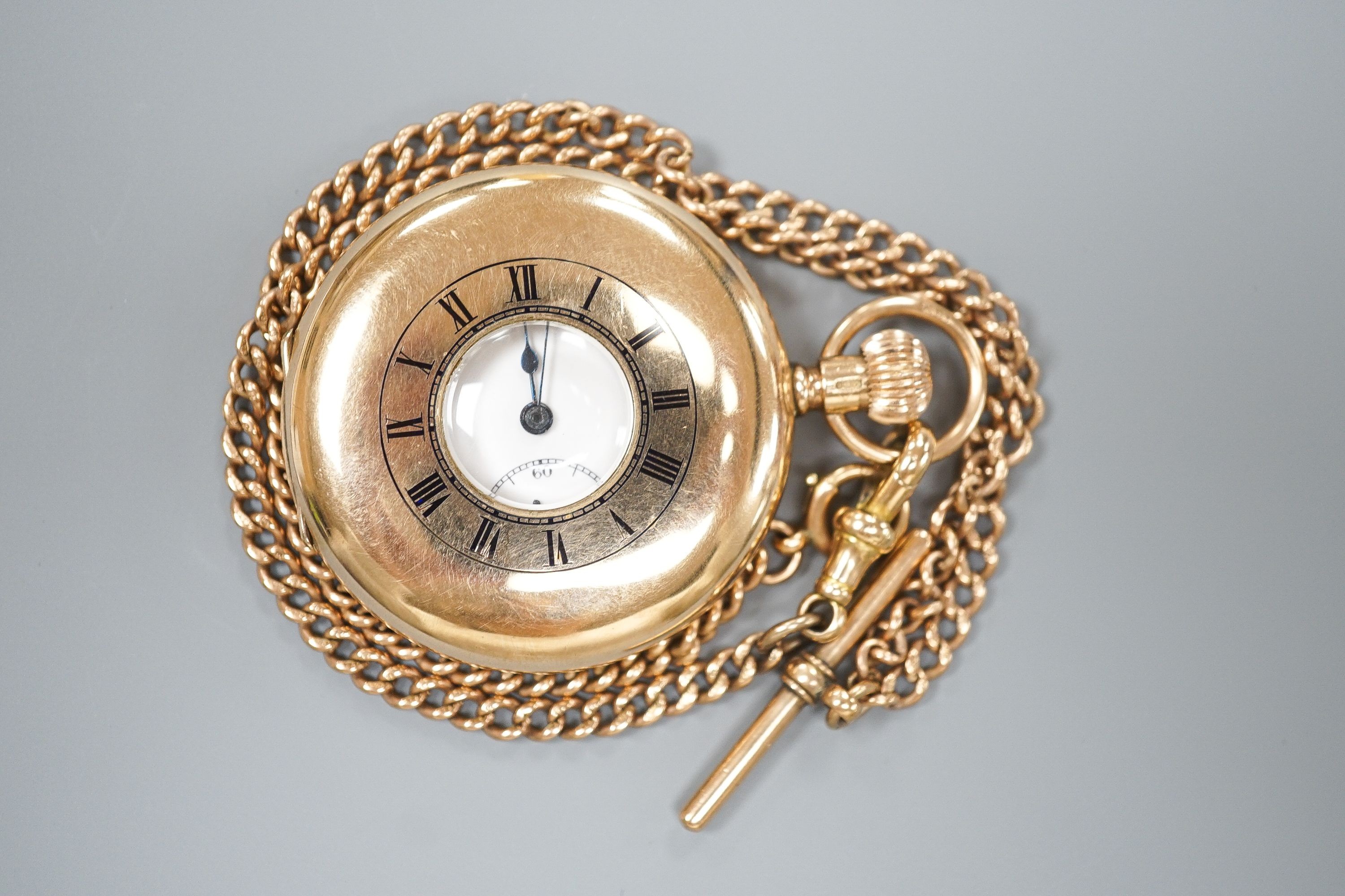 A George V 9ct gold half hunter pocket watch, 46mm, gross 74.9 grams, together with a 9ct gold cub link albert, 42cm, 21.2 grams.